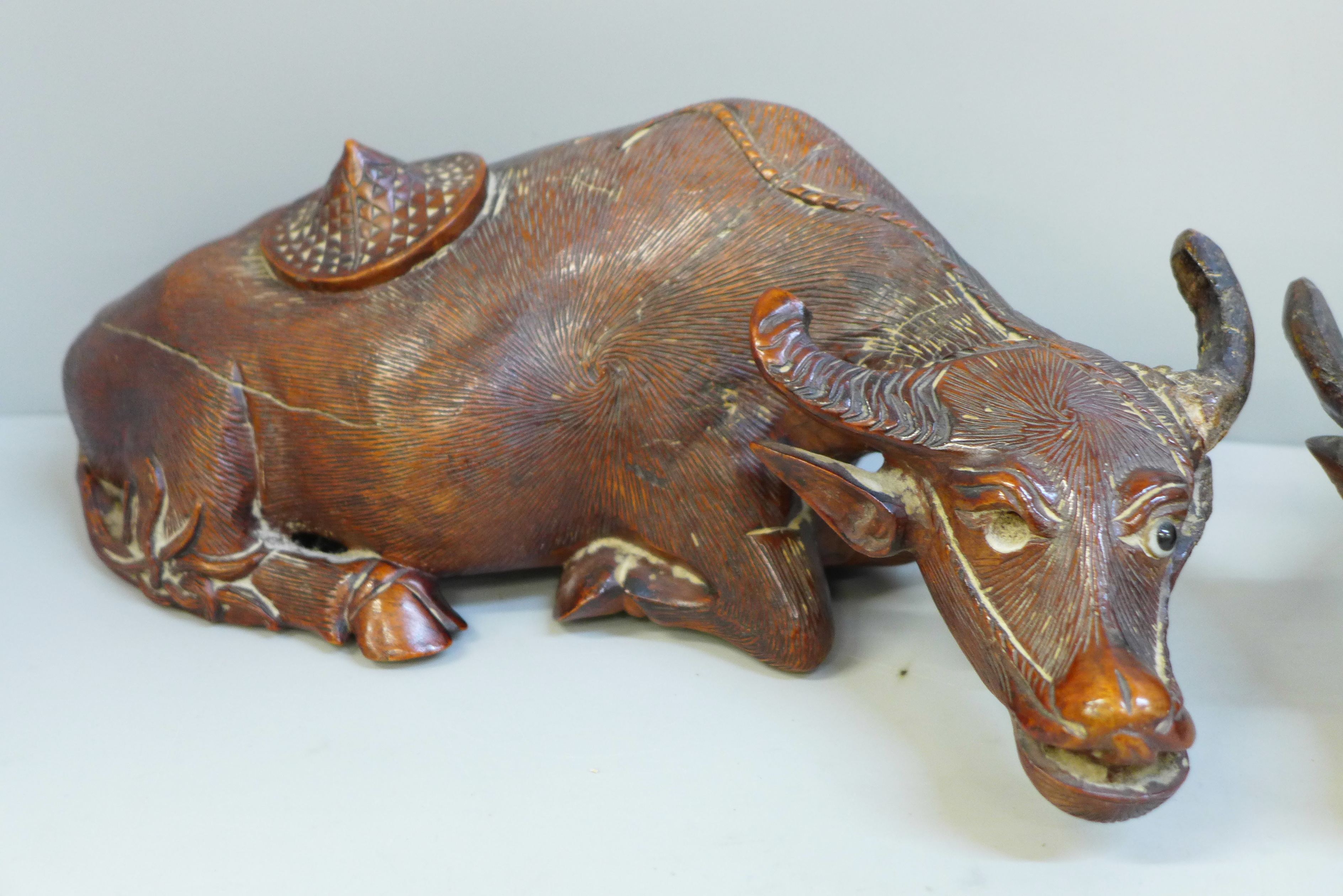 A pair of Chinese carved wooden models of water buffalo, both with damaged horns and splits to body, - Image 2 of 6