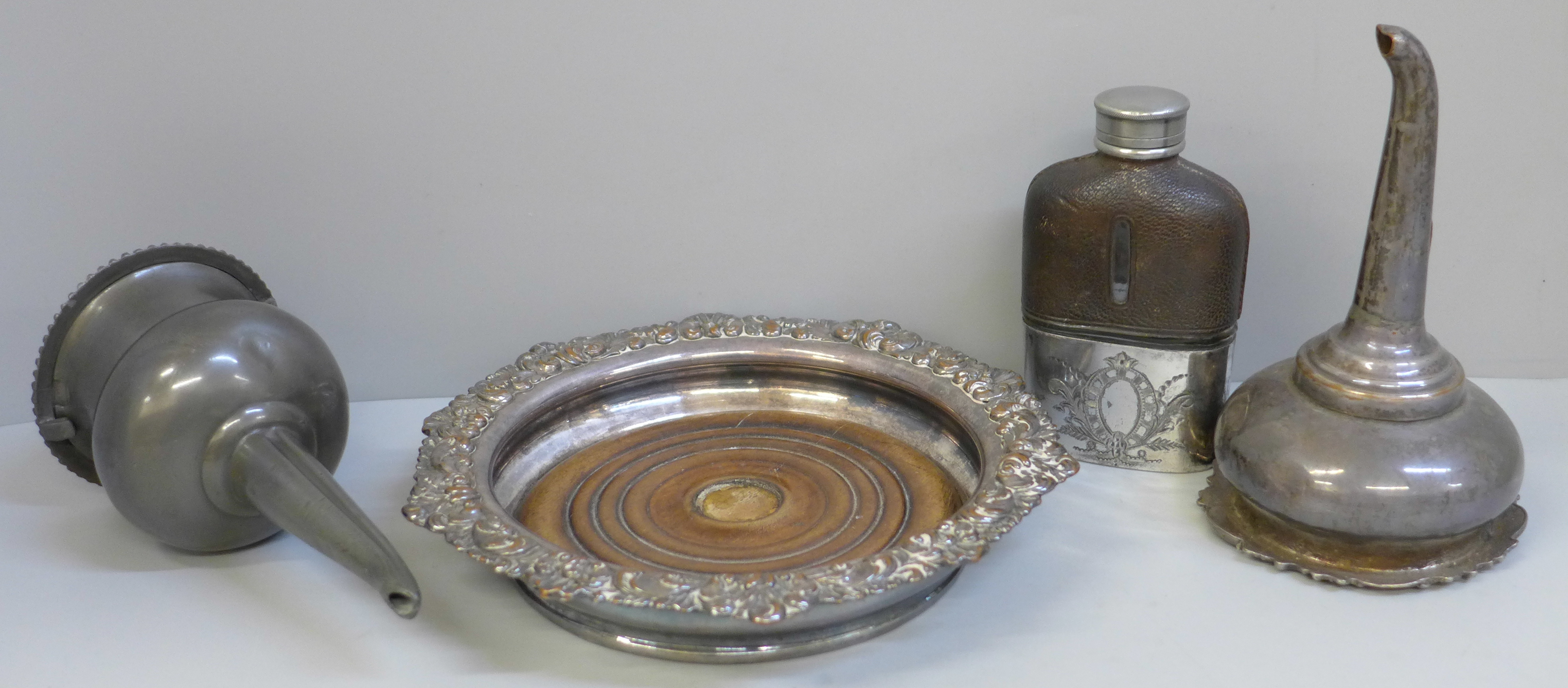 Two early 19th Century wine funnels, a plated wine coaster and a small hip flask