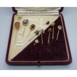 A collection of eleven pins; one 15ct gold and set with a small diamond, one 9ct gold and set with