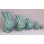 A graduated set of five Bourne Denby rabbits with matt green glaze