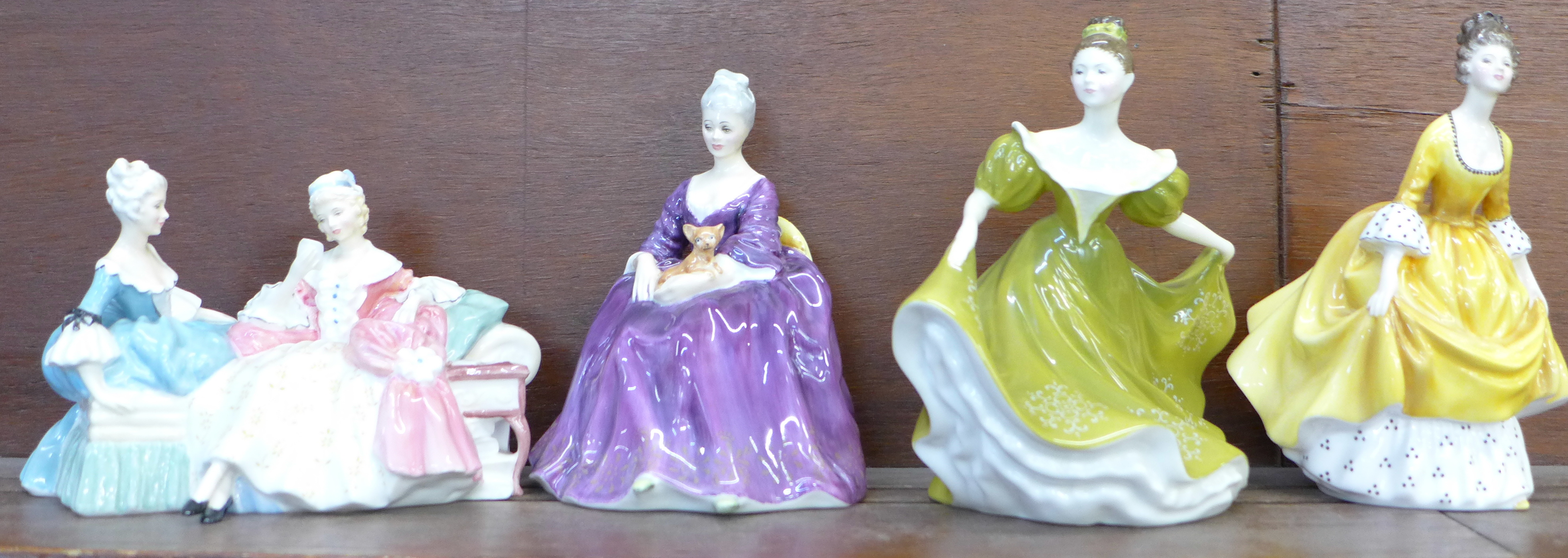 A Royal Doulton figure group, The Love Letter, and three Royal Doulton figures, Charlotte, Lynne and