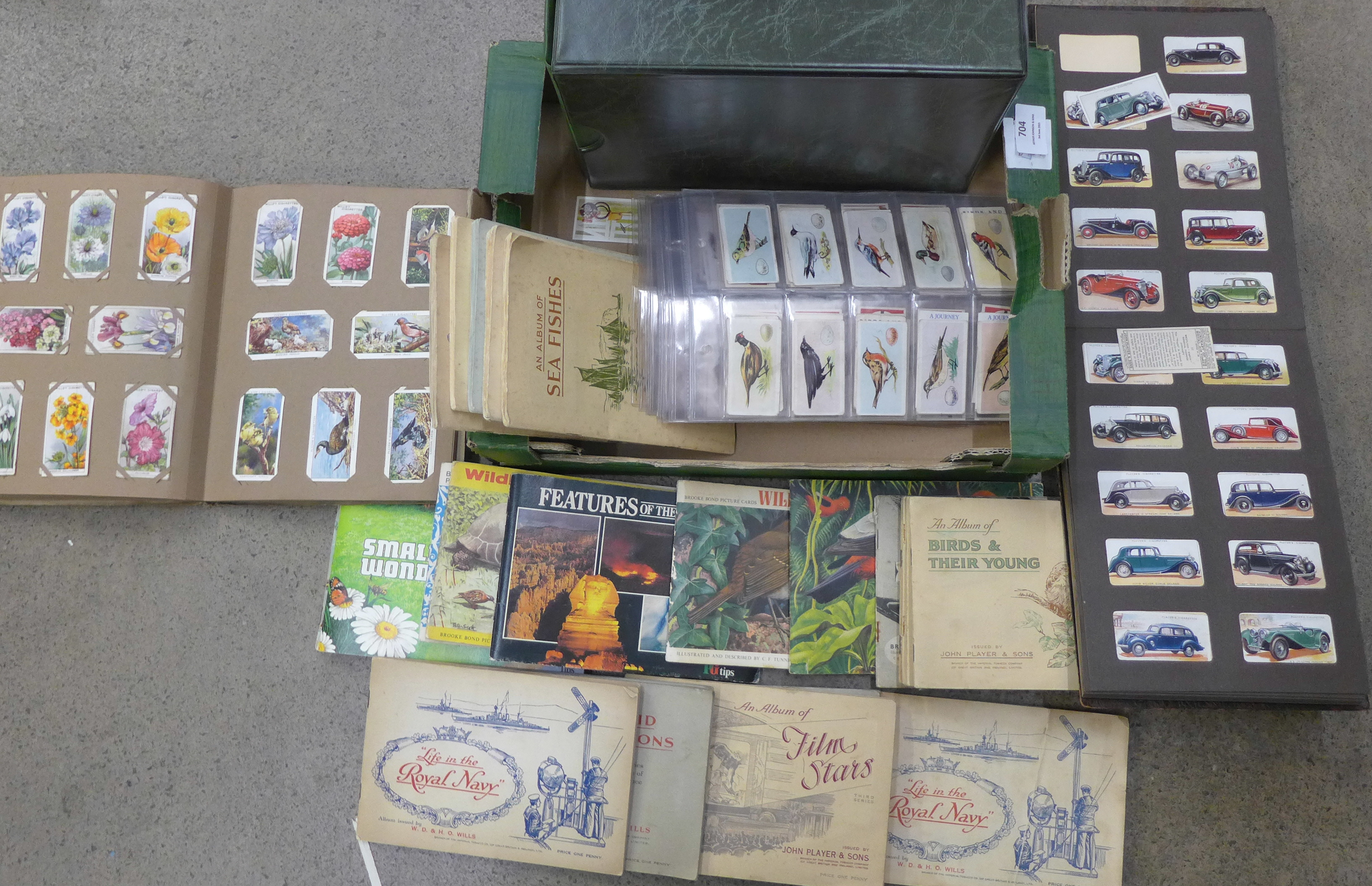 A box of cigarette and trade cards in albums and on sheets