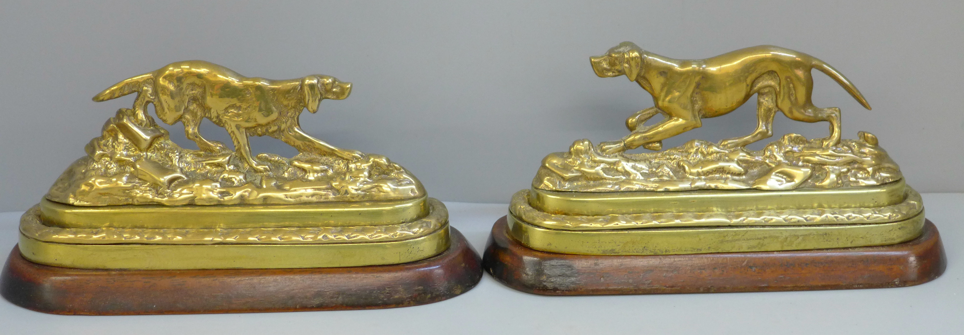 A pair of Victorian brass gun dogs on mahogany bases with traces of original gilding, 21cm