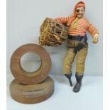 A pocket watch holder made from the teak of HMS Spartiatt and a model of a pirate with crab in