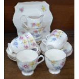 A Tuscan China Plant six setting tea service, six cups, saucers, side plates, a cake plate, sugar