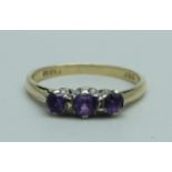 A 9ct gold and amethyst trilogy ring, 1.6g, L