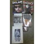 A collection of Bob Dylan books, newspaper cuttings and calendar