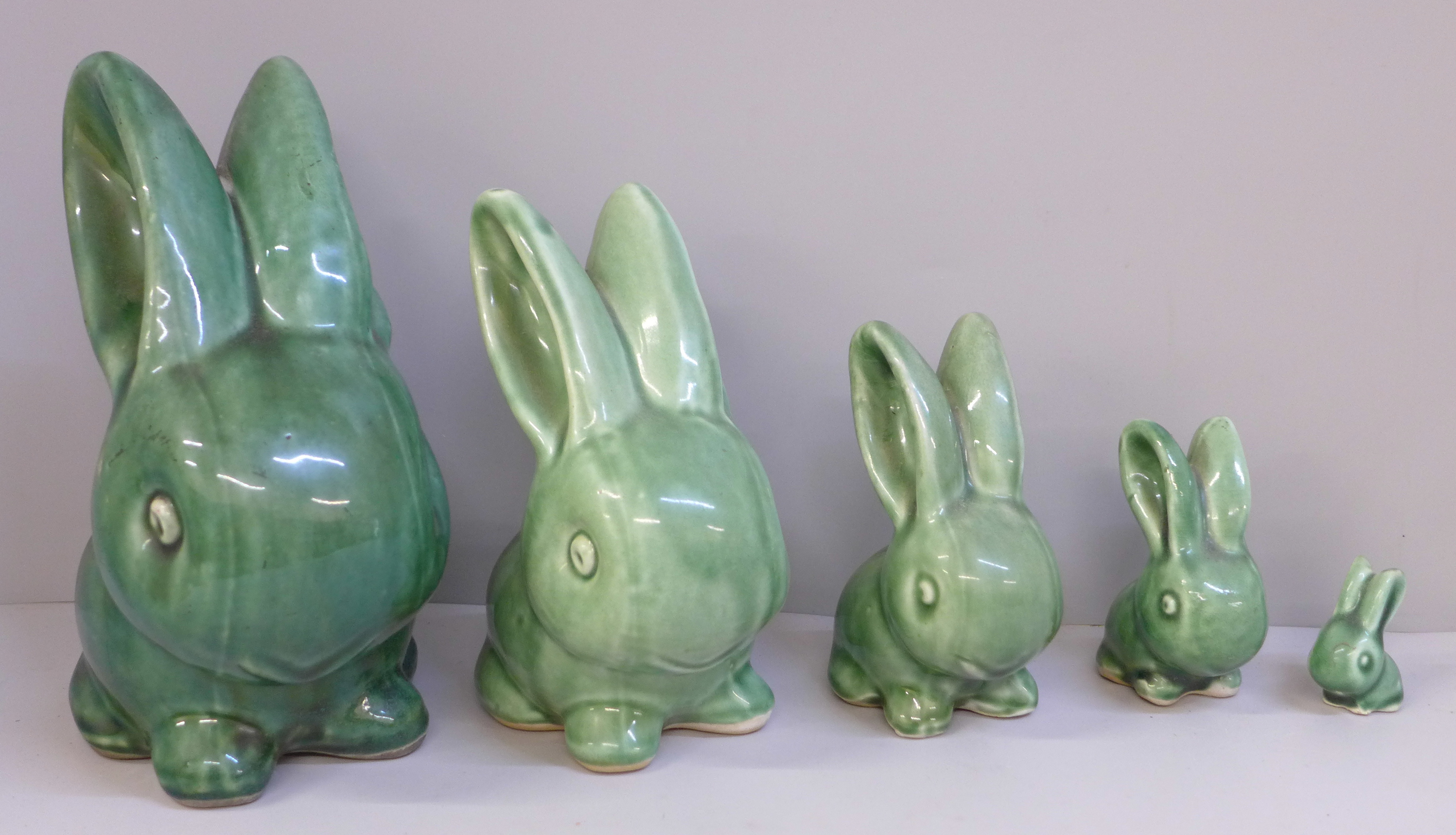 A graduated set of five Bourne Denby rabbits with glossy green glaze