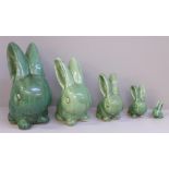 A graduated set of five Bourne Denby rabbits with glossy green glaze