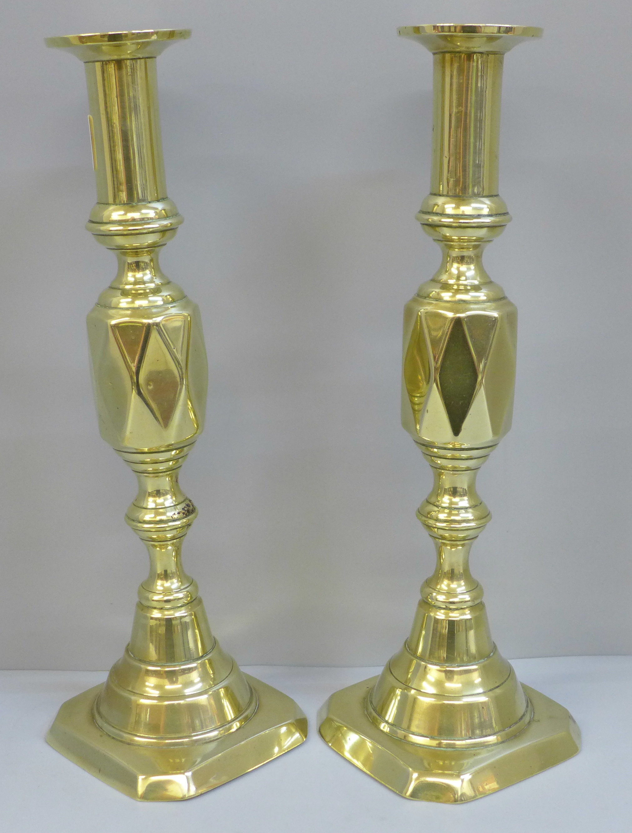 A pair of 19th Century Queen of Diamonds pattern brass candlesticks, 30cm