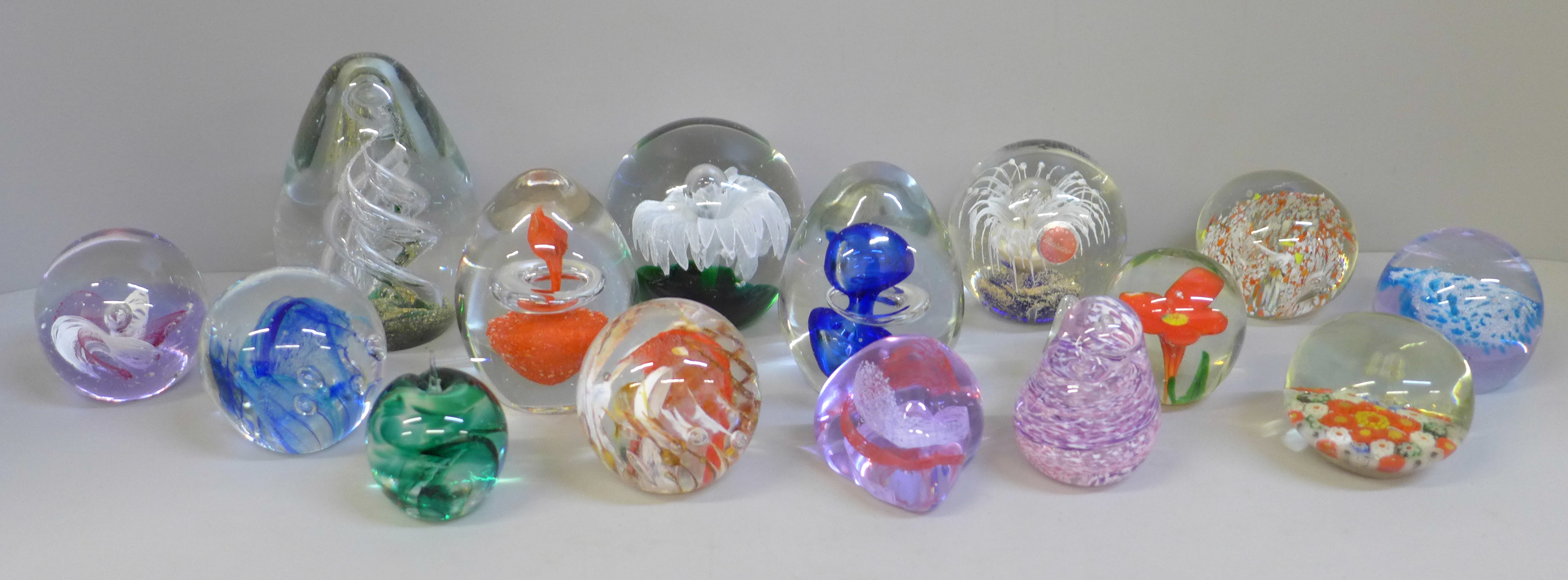 A collection of fifteen glass paperweights
