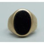 A yellow metal and onyx ring, (tests as 9ct gold), 3.5g, I
