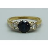 An 18ct gold, diamond and sapphire three stone ring, 3.2g, O