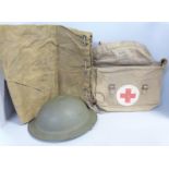 A helmet, kit bag and a Red Cross canvas bag