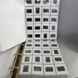 Two folders of colour photographic slides, with detailed index of locations and dates, range from