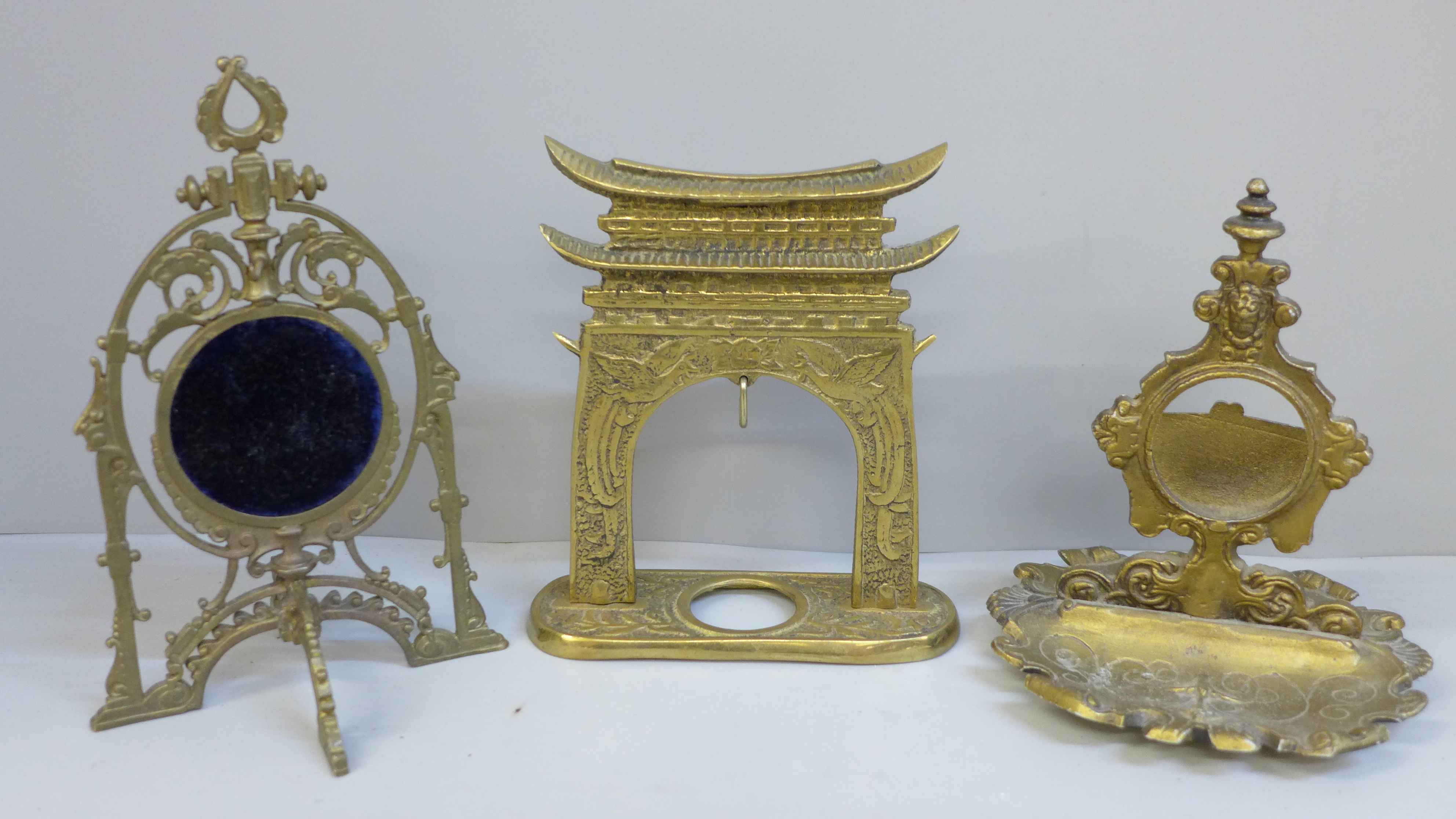 Three watch stands including one in the form of an oriental gate