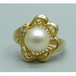 A 14ct gold, pearl and three stone diamond ring, 3.9g, O