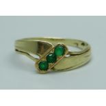 A 585 14ct gold, emerald three stone ring, 1.8g, N