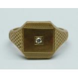 A 9ct gold signet ring set with a diamond, 9.3g, X