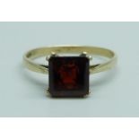 A 9ct gold and red stone solitaire ring, 1.4g, N