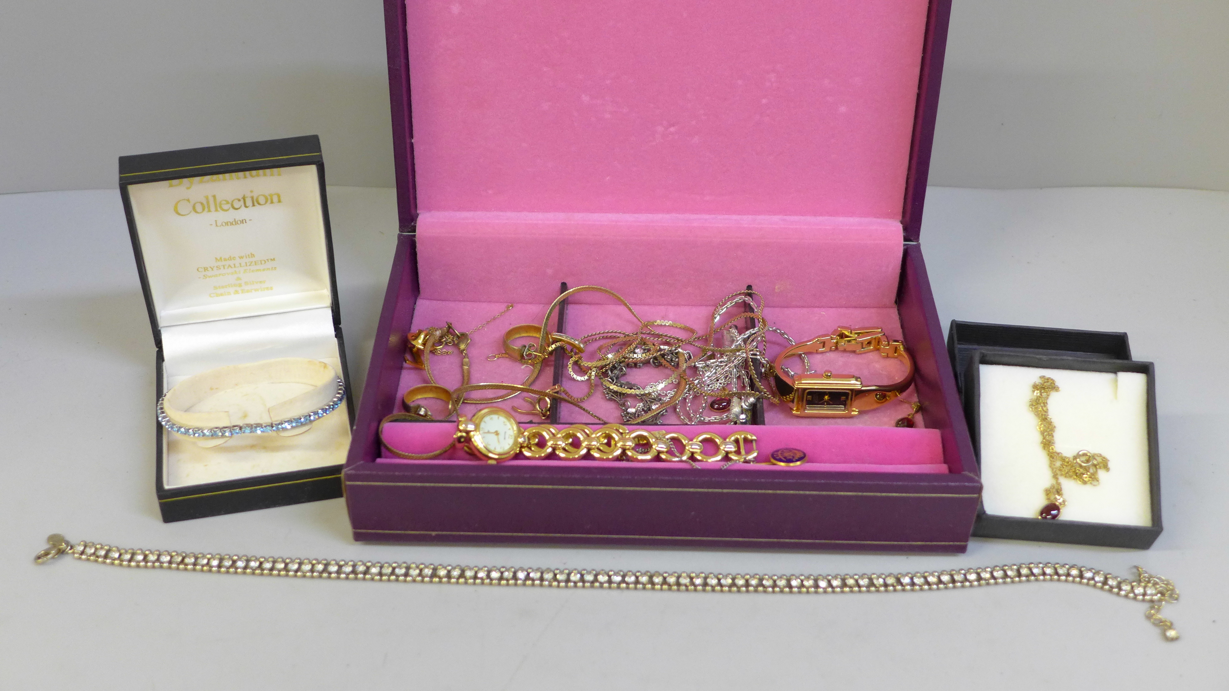 Costume jewellery, a yellow metal wishbone pendant and chain and two lady's wristwatches