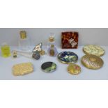 A collection of compacts and perfume bottles including Chanel No.5 miniatures