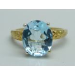 A silver gilt and large blue topaz solitaire ring, Q