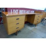 A teak concave desk