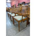 A set of four teak dining chairs