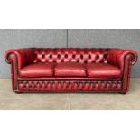 An oxblood red leather Chesterfield settee