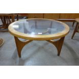 A Stonehill Stateroom teak and glass topped circular coffee table