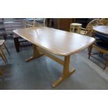 An Ercol Blonde elm and beech refectory table