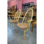 A pair of Ercol Blonde elm and beech Quaker elbow chairs