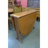 A teak drop-leaf table