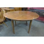 A teak circular dining table