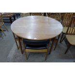 A McIntosh teak circular extending dining table and four chairs