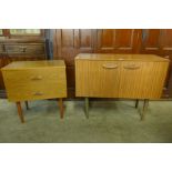 A small teak sideboard and a chest of drawers