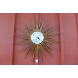 A Seth Thomas teak sunburst wall clock