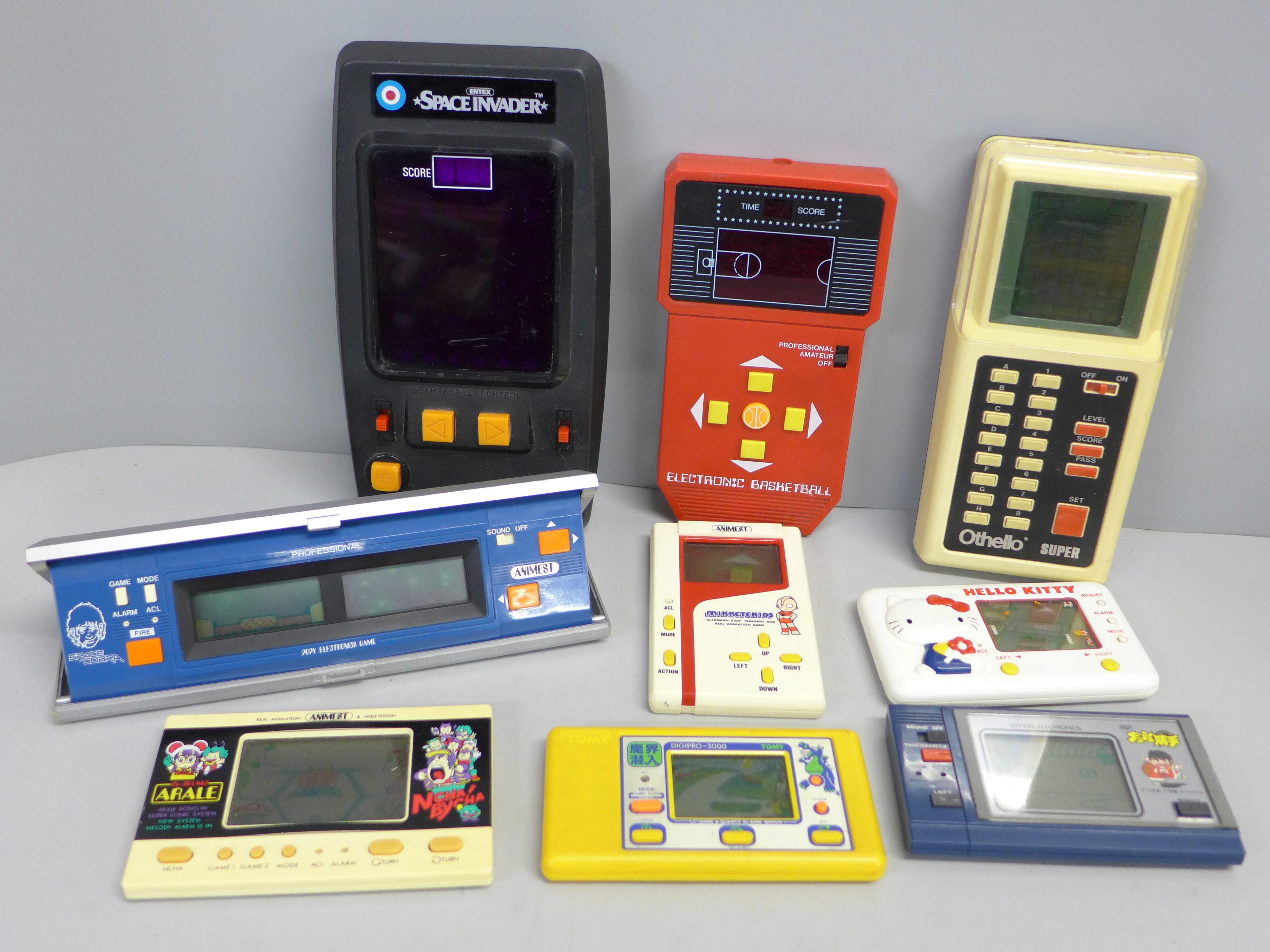 Eight vintage hand held games; Space Invaders, Animest Mikketekids, Bandai electronic basketball,