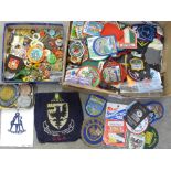 A large collection of cloth and enamel badges including Scouting