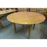 A teak circular dining table