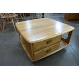 An Ercol Blonde elm Pandora's Box coffee table