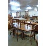 A McIntosh teak extending dining table and eight chairs