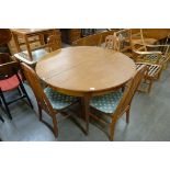 A Sutcliffe of Todmorden S-Form teak extending dining table and four teak dining chairs