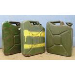 Three vintage green metal Jerry cans