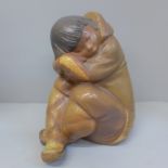 A Lladro figure of a sleeping Inuit boy, 26cm