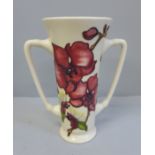 A Moorcroft Orchid pattern loving cup, 16cm