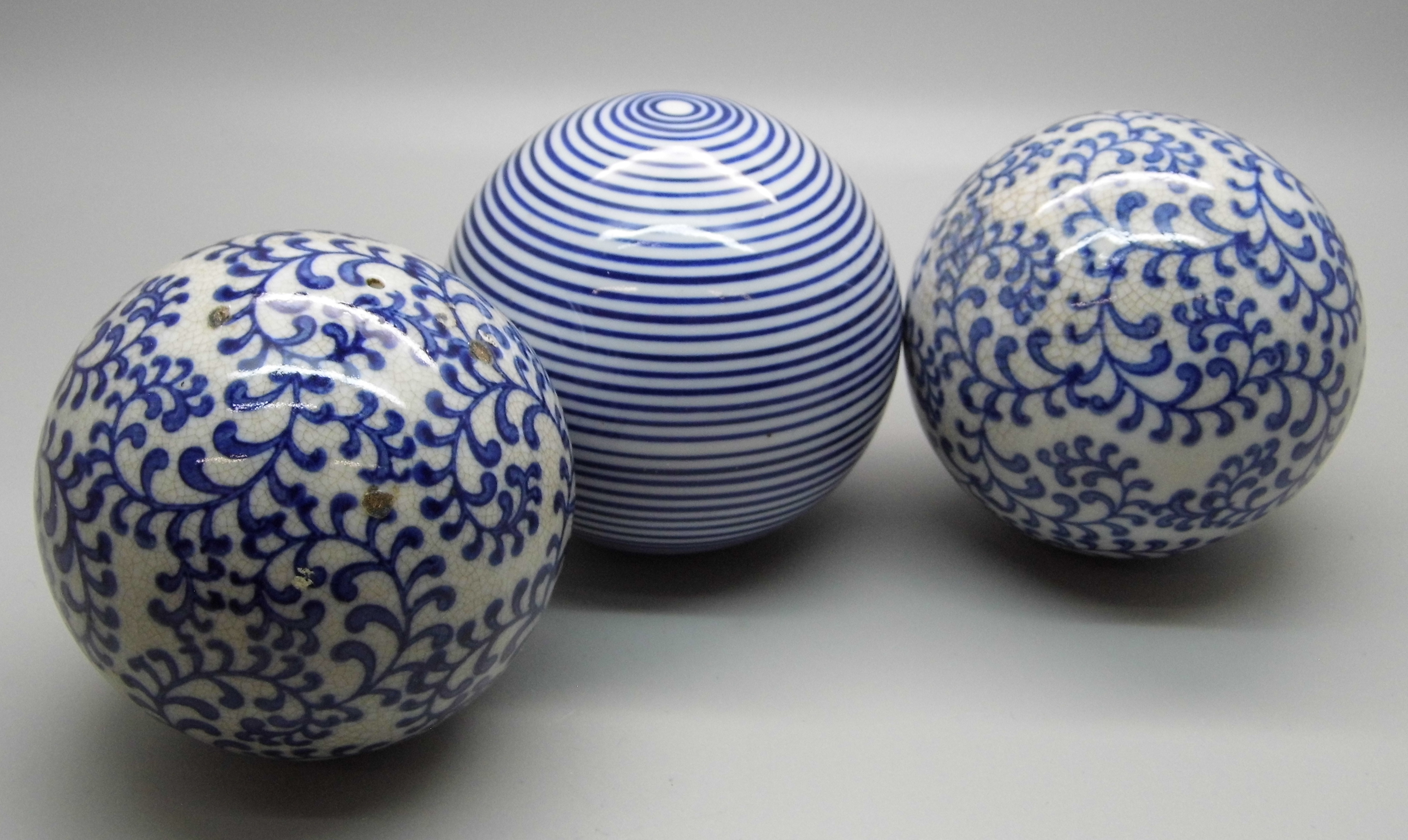 Three blue and white carpet bowls