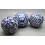 Three blue and white carpet bowls