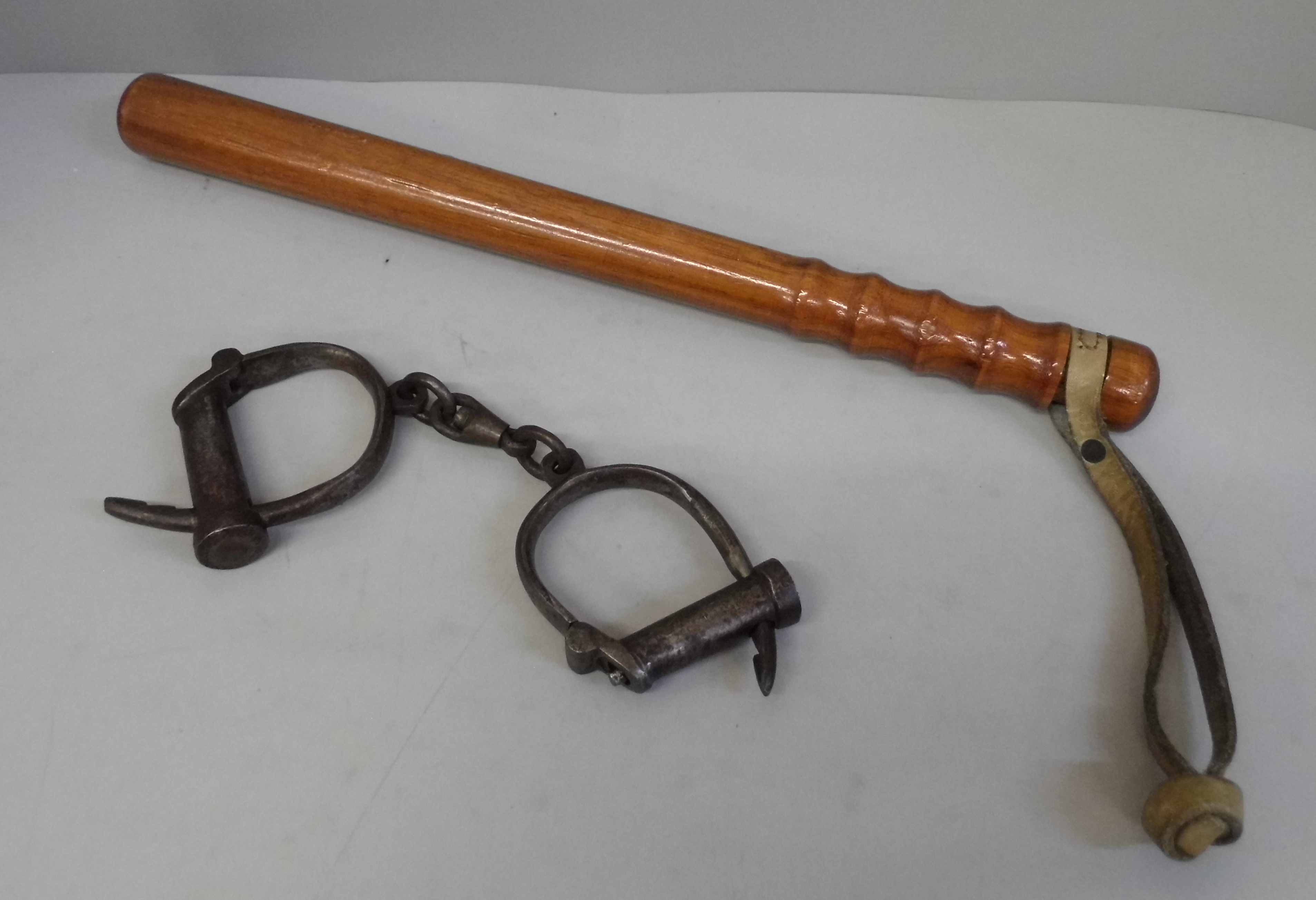 A wooden truncheon and a pair of handcuffs